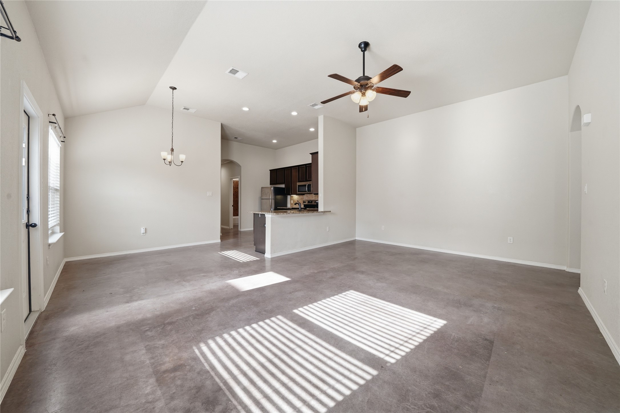 533 Jack Rabbit Lane, Unit A Buda, TX 78610 - Photo 34 of 34 An open floor plan seamlessly connects the well-lit living area to a modern kitchen.