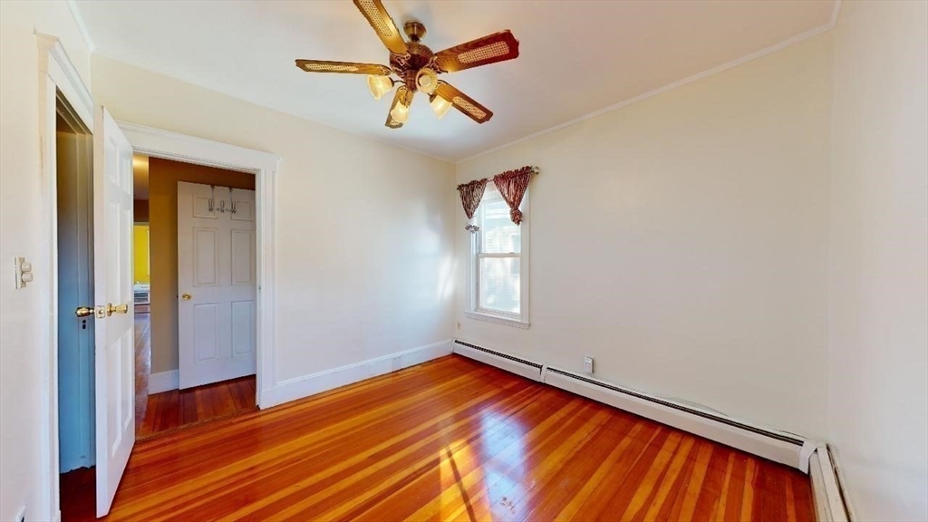 17 Gorham Road, Unit 2 Medford, MA 02155 - Photo 17 of 37 a view of empty room with wooden floor
