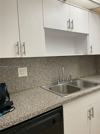 a view with a sink and cabinets