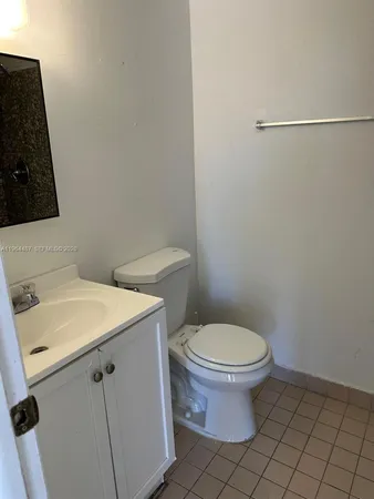 a white toilet sitting next to a bathroom sink