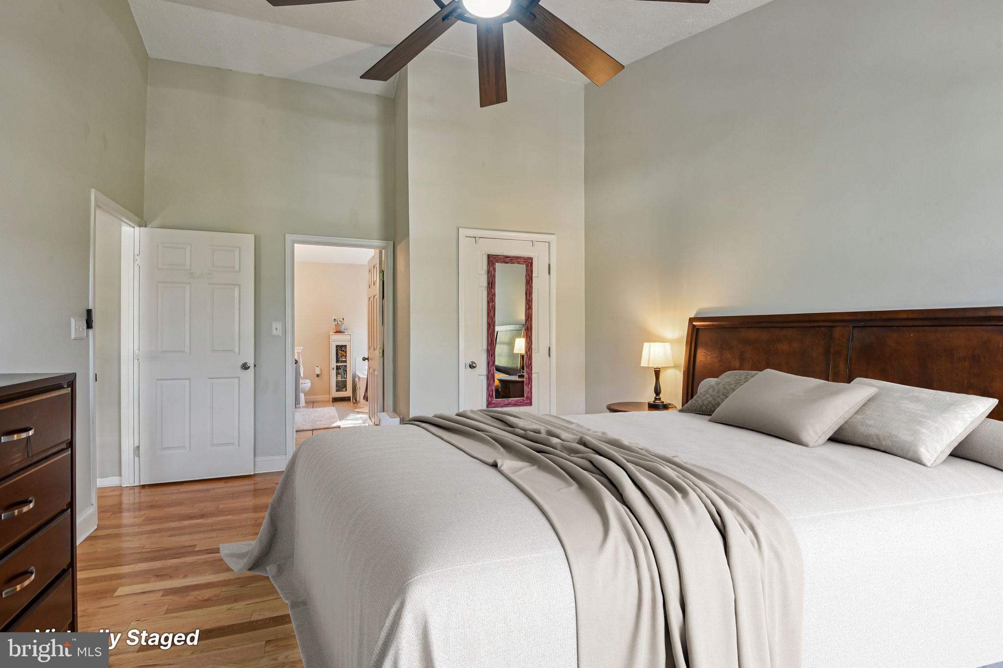 7617 Bear Forest Road Hanover, MD 21076 - Photo 15 of 37 a bedroom with a bed and a chandelier