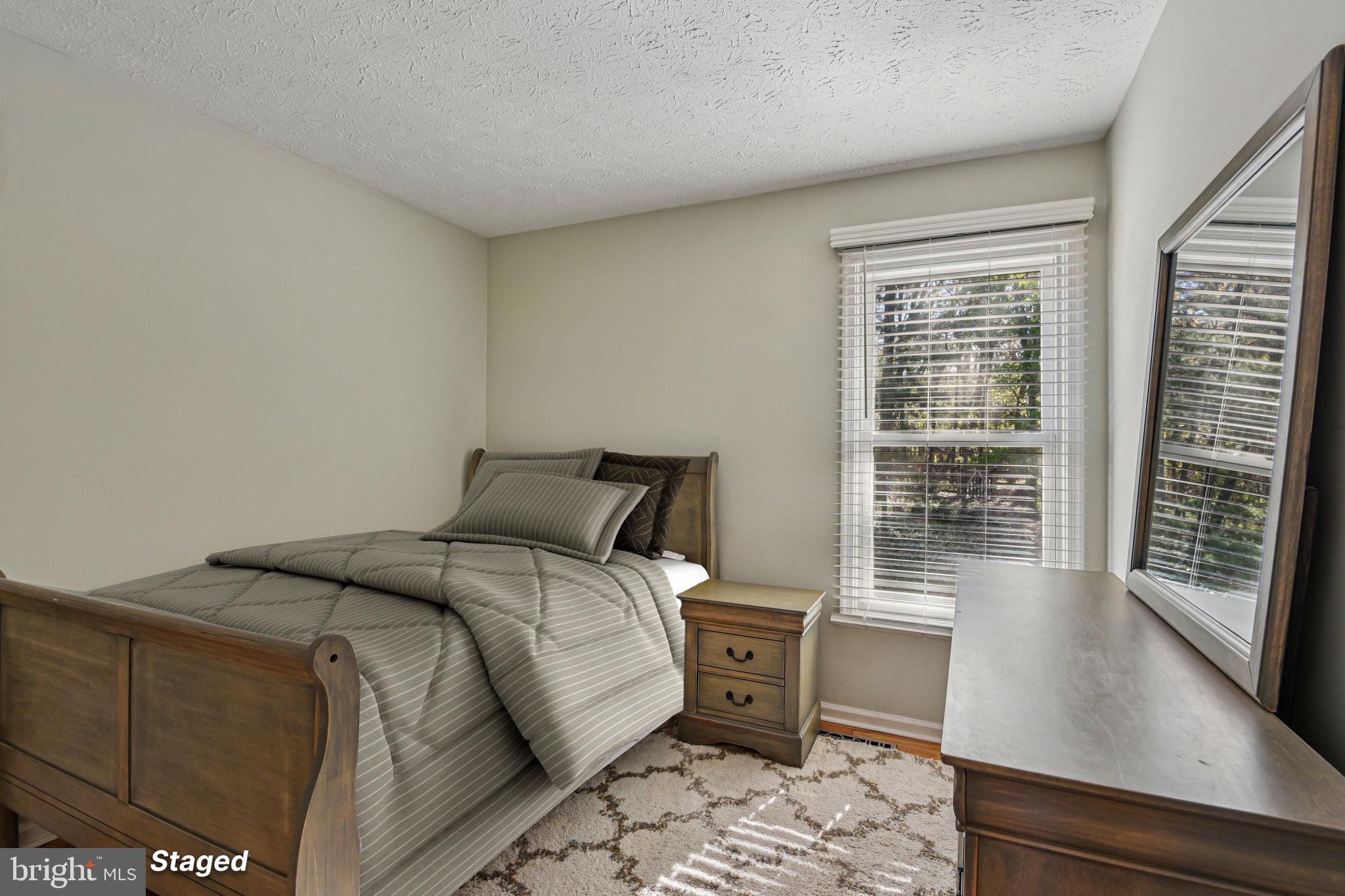 7617 Bear Forest Road Hanover, MD 21076 - Photo 21 of 37 a bed sitting in a bedroom next to a window