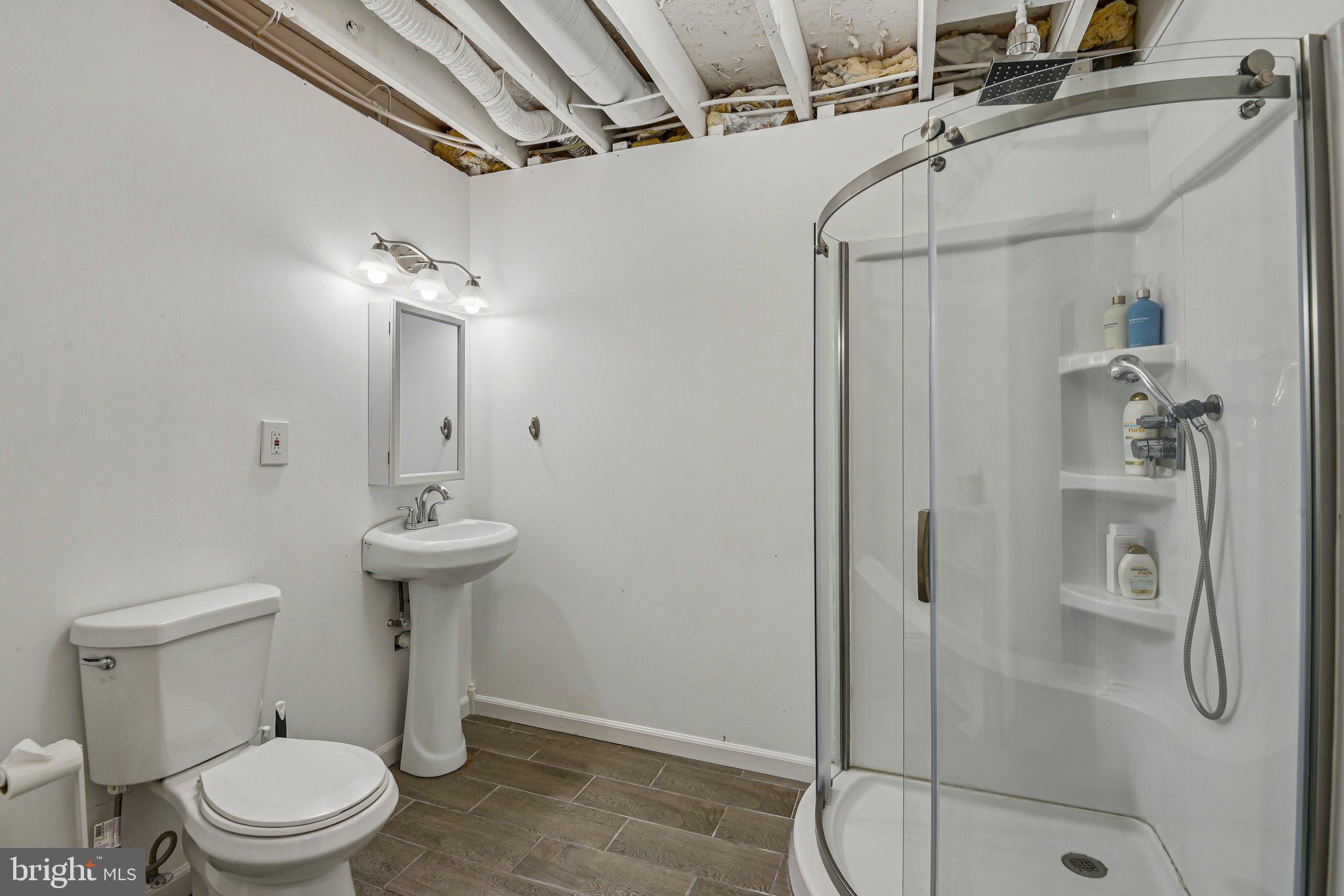 7617 Bear Forest Road Hanover, MD 21076 - Photo 28 of 37 a bathroom with a shower a toilet and sink