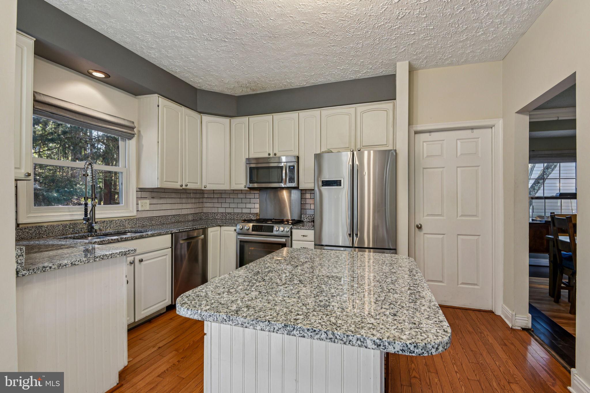 7617 Bear Forest Road Hanover, MD 21076 - Photo 6 of 37 a kitchen with stainless steel appliances granite countertop a sink stove and refrigerator