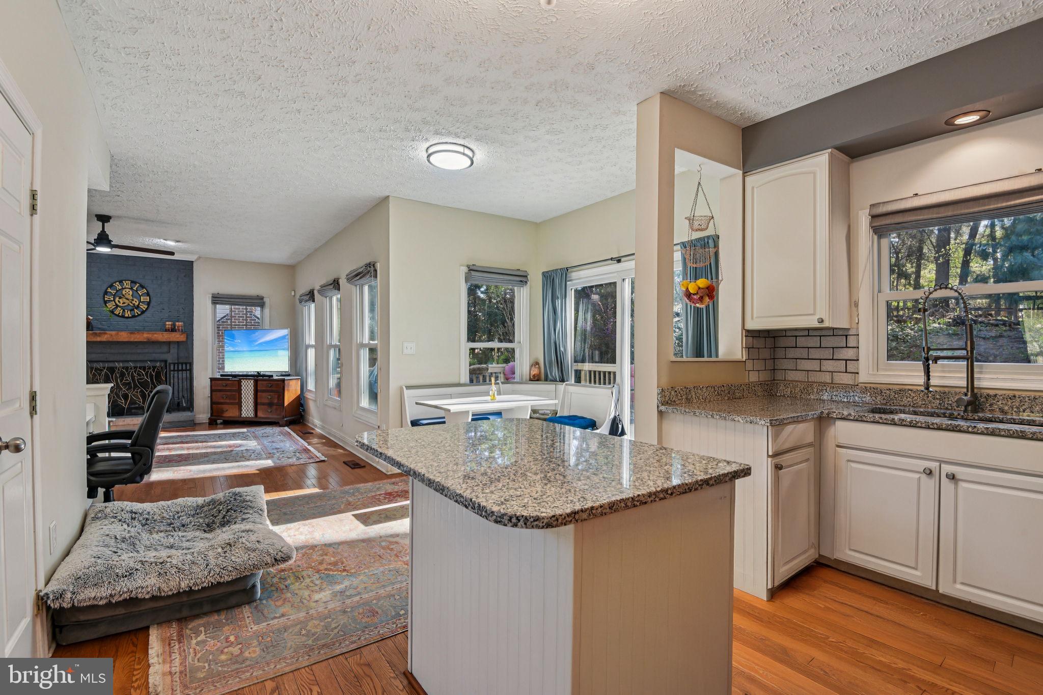 7617 Bear Forest Road Hanover, MD 21076 - Photo 8 of 37 a large kitchen with granite countertop a sink and dishwasher with a large kitchen island