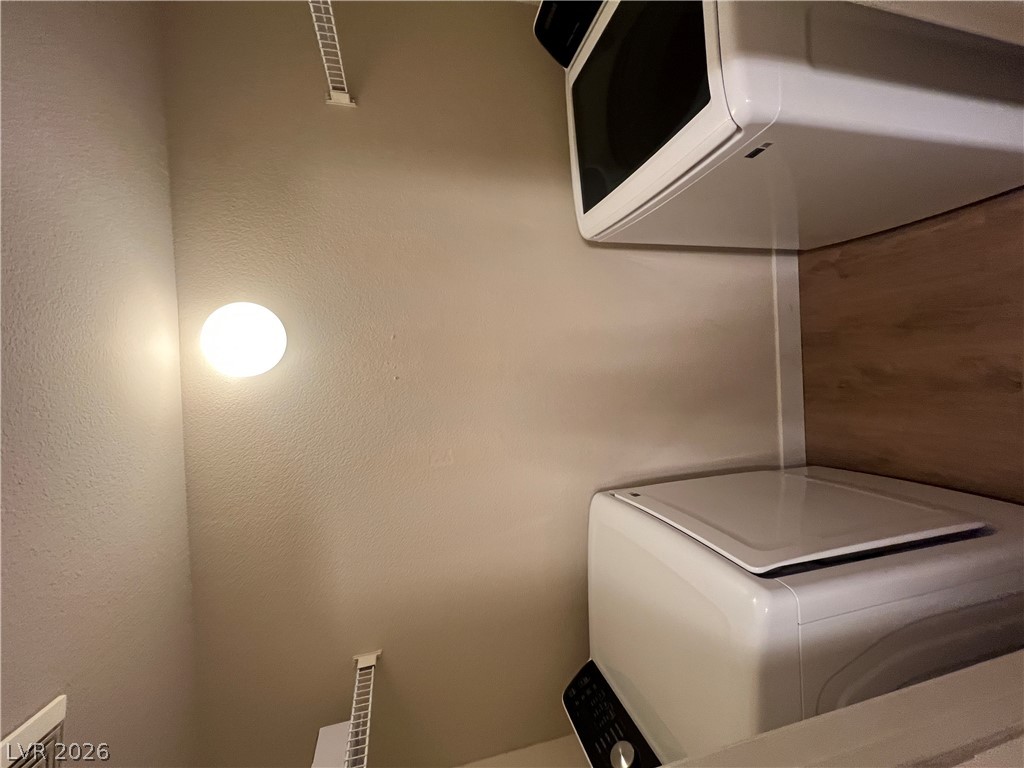 7255 West Sunset Road, Unit 2057 Las Vegas, NV 89113 - Photo 9 of 12 A dedicated laundry closet offers efficient, stacked appliances for convenient clothing care.