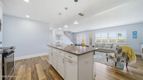 a kitchen with granite countertop a sink and a stove top oven