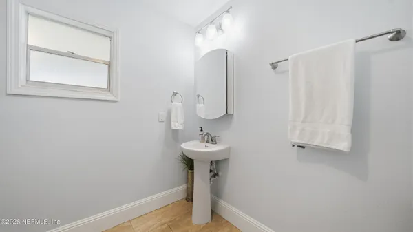 a bathroom with a sink a mirror and vanity