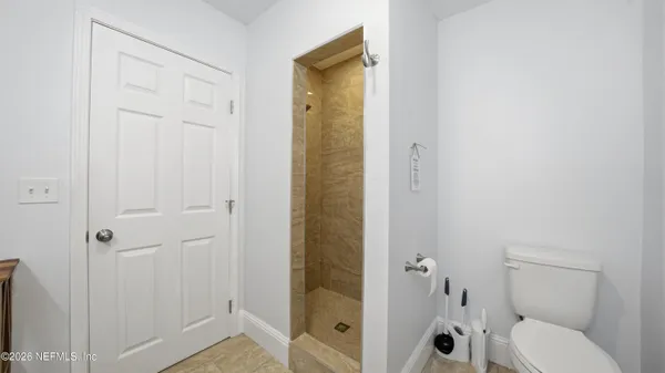 a bathroom with a shower and a toilet