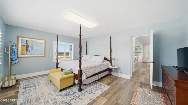 a bedroom with a bed a table and chair
