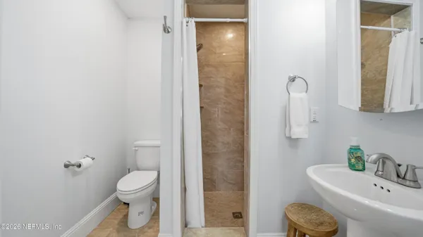 a bathroom with a sink a toilet and mirror