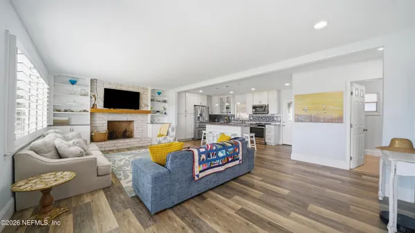 a living room with fireplace furniture and a flat screen tv