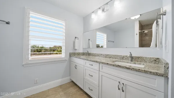 a bathroom with a bathtub and shower