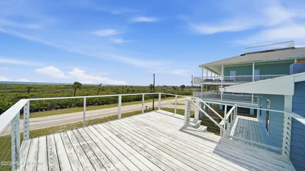 a view of a chair and table on the wooden deck