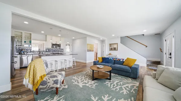 a living room with furniture and kitchen view