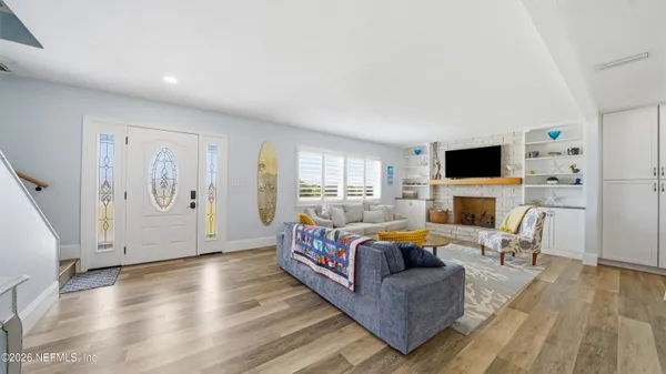 a bedroom with furniture and wooden floor