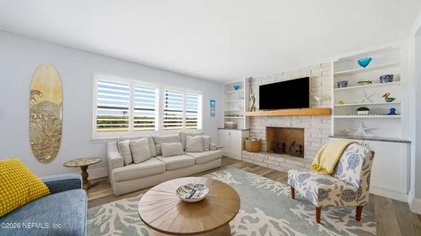 a living room with furniture fireplace and a flat screen tv