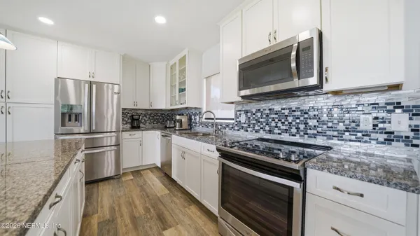 a kitchen with granite countertop cabinets and steel stainless steel appliances