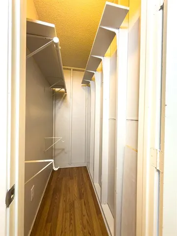 a view of walk in closet with empty racks