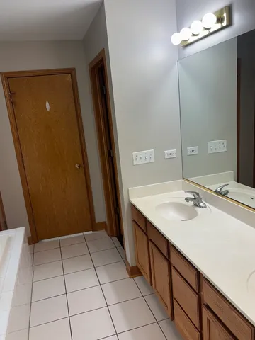 a bathroom with a sink a mirror and a shower