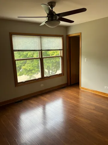 a view of a livingroom with wooden floor and a window