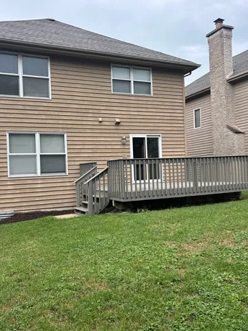 a view of a house with backyard and sitting area