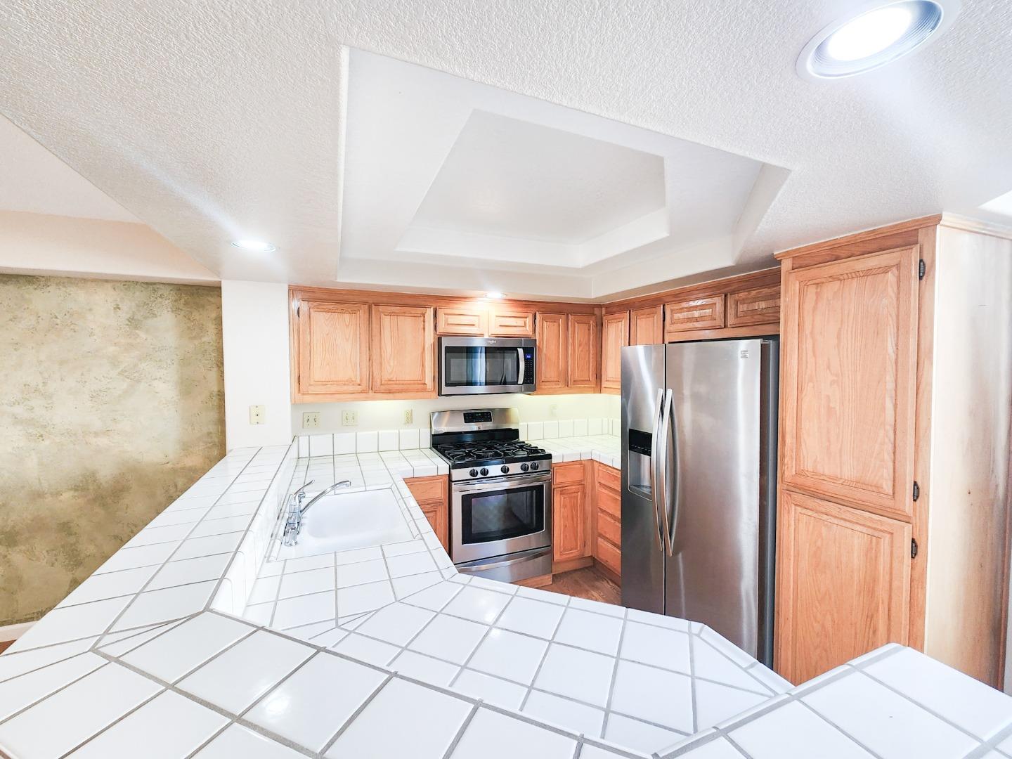 10 Patrick Way Half Moon Bay, CA 94019 - Photo 5 of 11 a kitchen with stainless steel appliances granite countertop a refrigerator and a sink