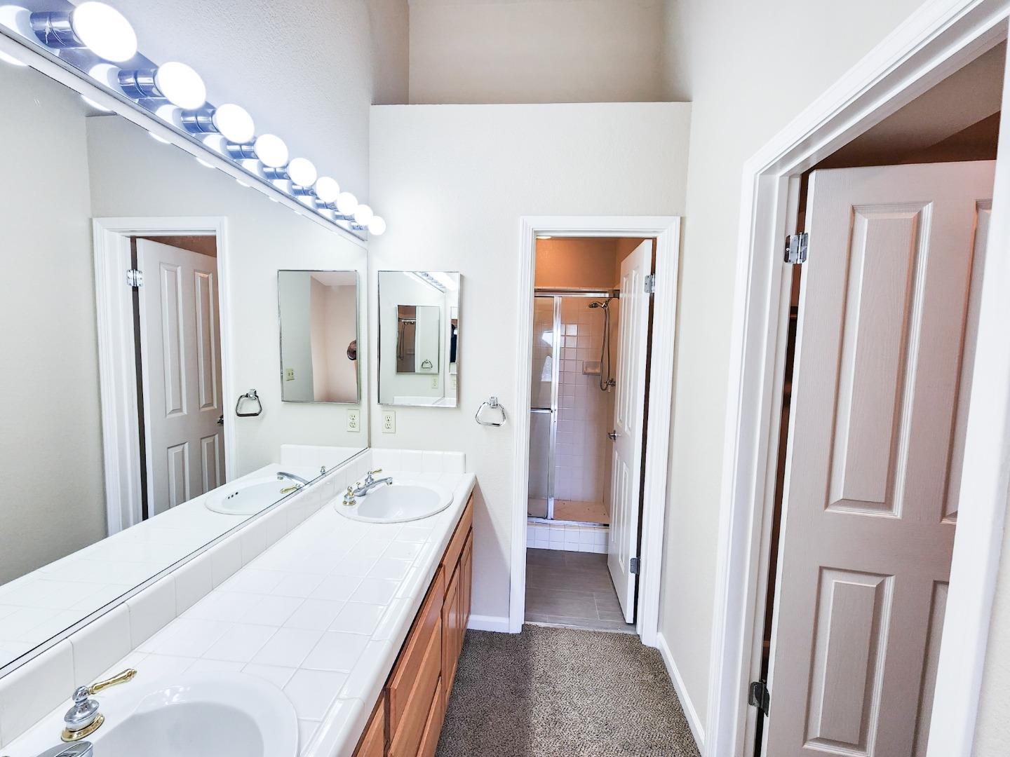 10 Patrick Way Half Moon Bay, CA 94019 - Photo 9 of 11 a en suite bathroom with a double vanity sink and a mirror