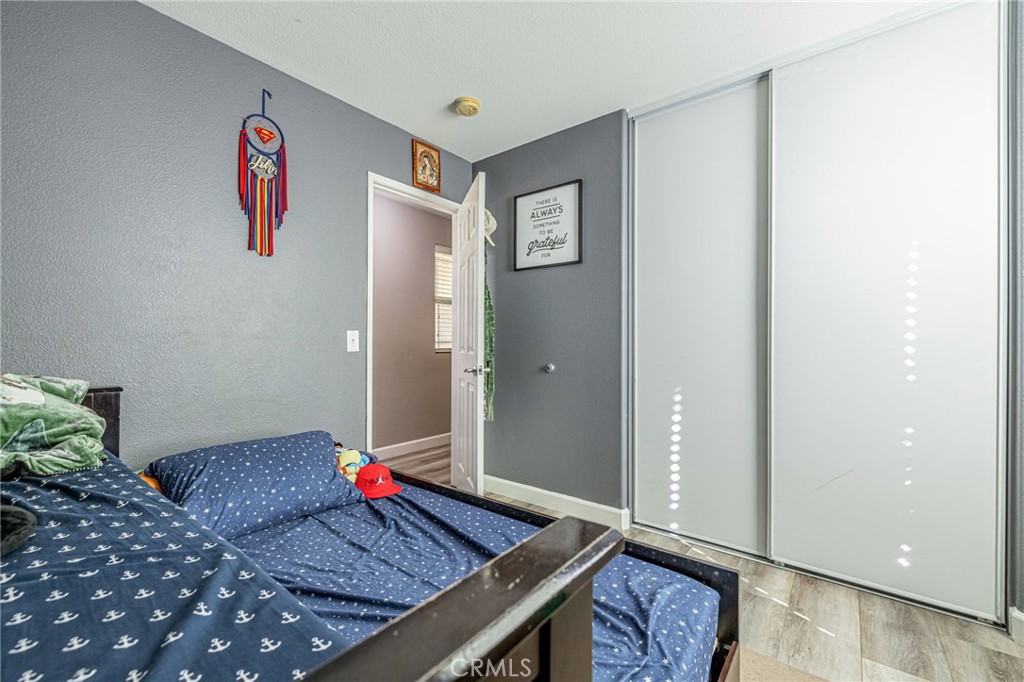 43128 Homestead Street Lancaster, CA 93535 - Photo 26 of 33 a living room with rug and wall paintings