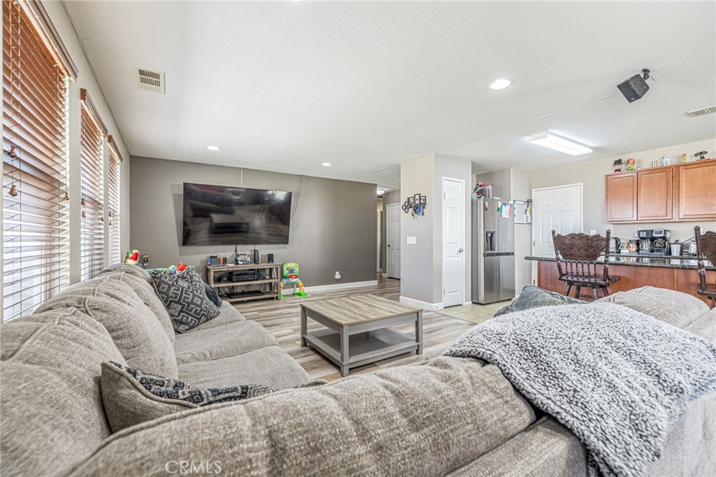43128 Homestead Street Lancaster, CA 93535 - Photo 28 of 33 a living room with furniture and a flat screen tv