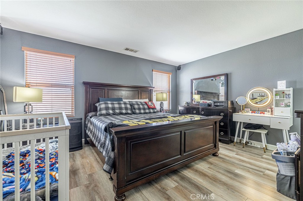 43128 Homestead Street Lancaster, CA 93535 - Photo 29 of 33 a kitchen with stainless steel appliances and wooden floor