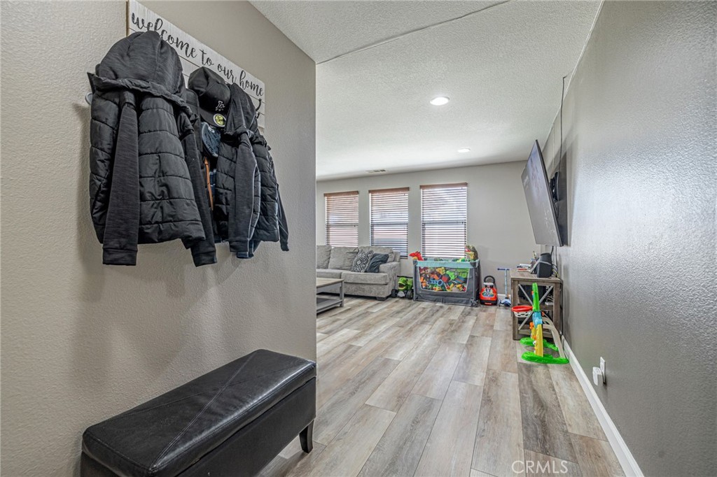43128 Homestead Street Lancaster, CA 93535 - Photo 30 of 33 a view of a hallway with wooden floor and windows