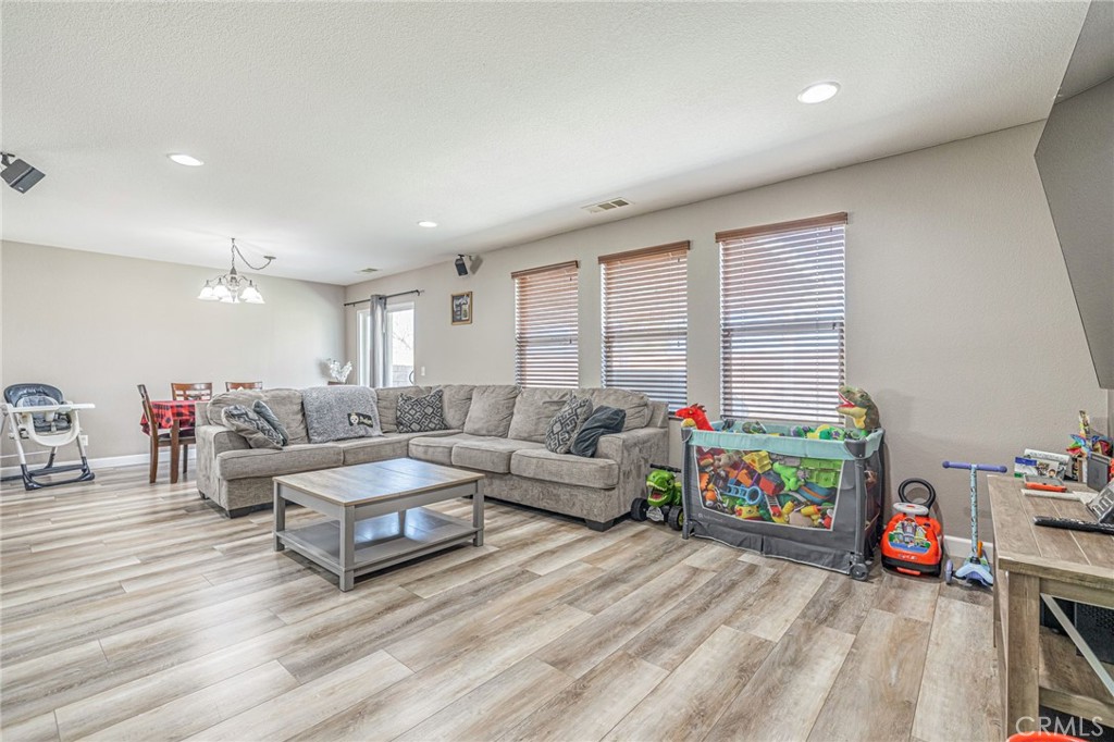43128 Homestead Street Lancaster, CA 93535 - Photo 32 of 33 a living room with furniture and a wooden floor