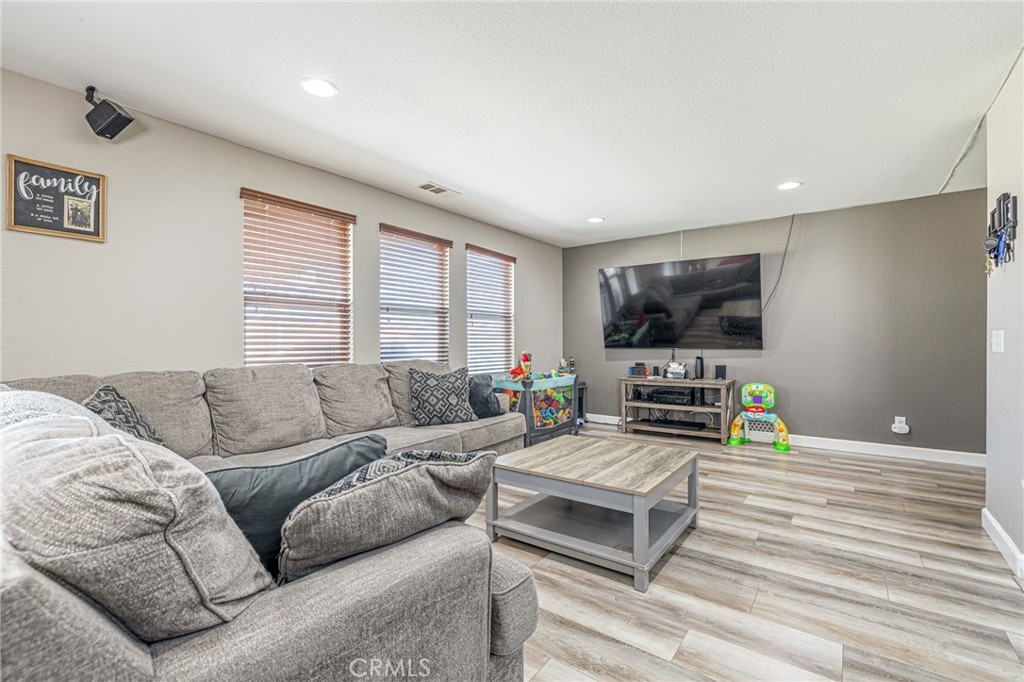 43128 Homestead Street Lancaster, CA 93535 - Photo 33 of 33 a living room with furniture and a flat screen tv