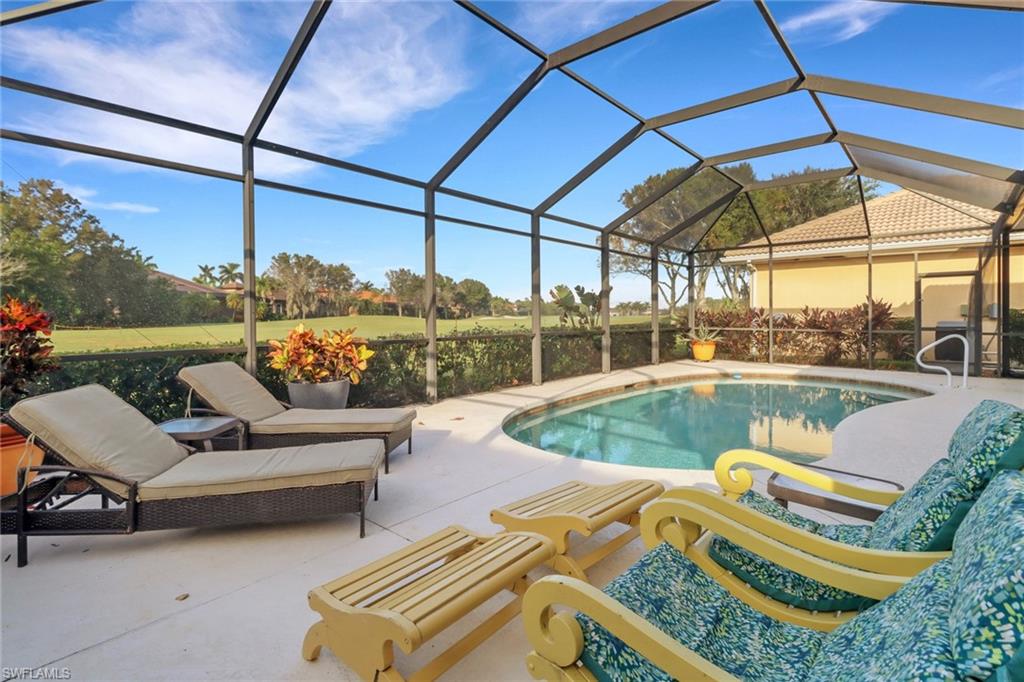 6757 Bent Grass Drive Naples, FL 34113 - Photo 26 of 27 a view of a swimming pool with a patio