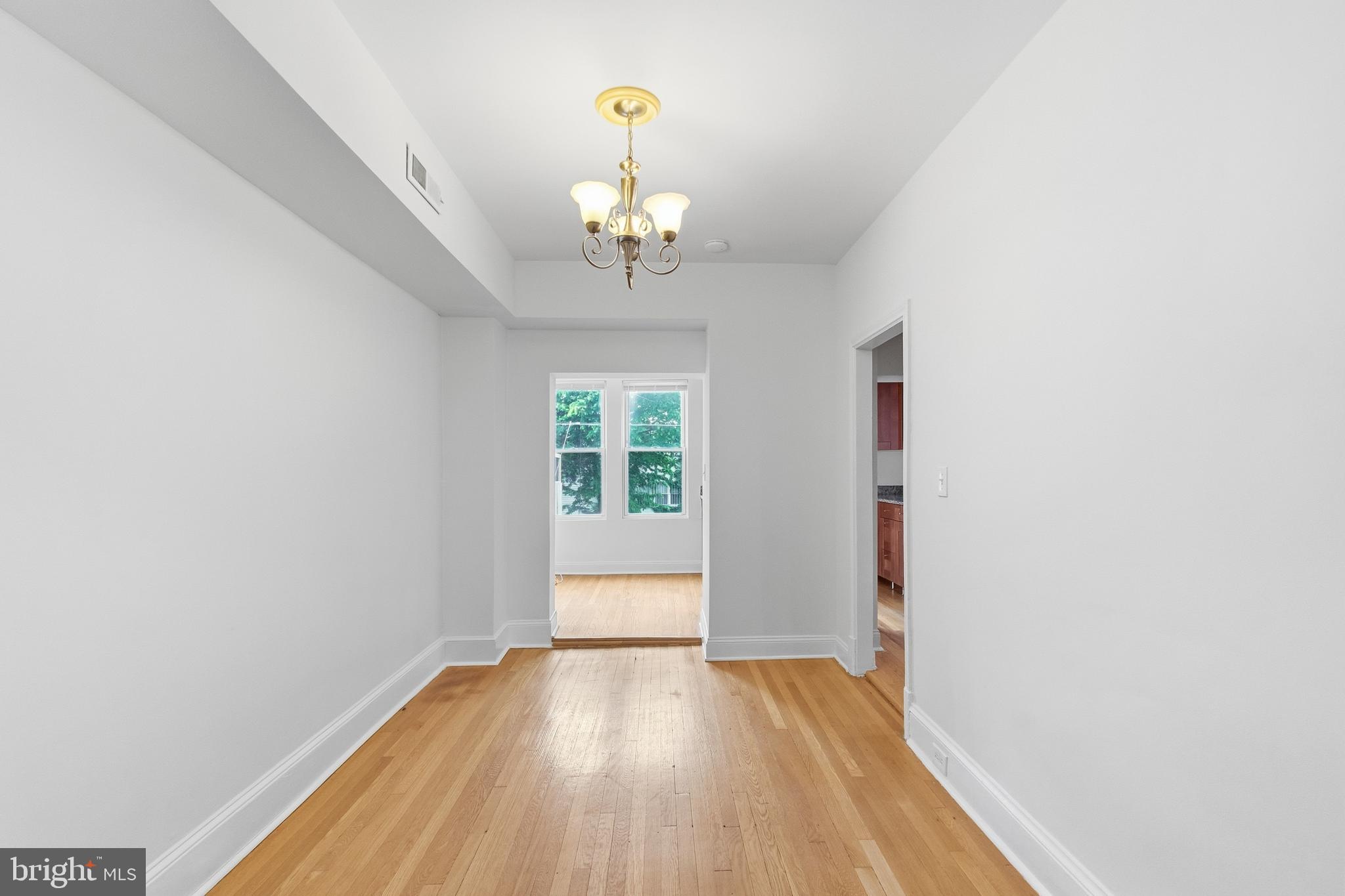 440 Delafield Place Northwest Washington, DC 20011 - Photo 9 of 33 wooden floor in an empty room with a window