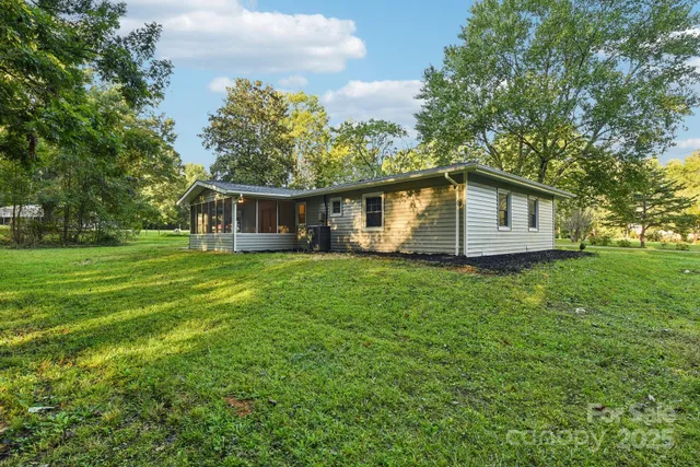 a view of a house with a backyard