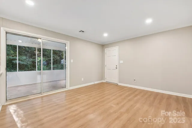 a view of empty room with large windows