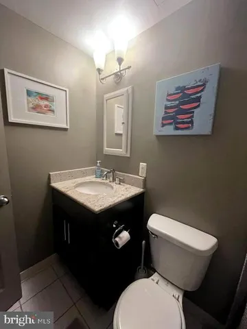 a bathroom with a toilet a sink and mirror