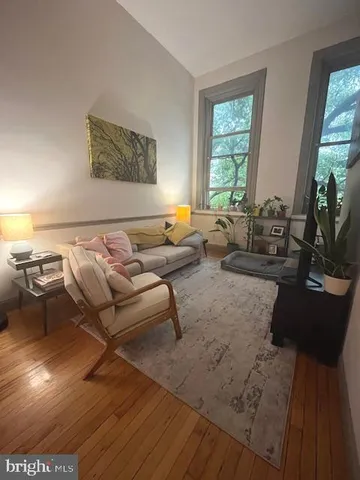 a living room with furniture and floor to ceiling windows