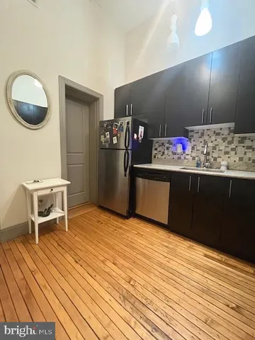 a view of a room with wooden floor and furniture