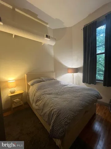 a bedroom with a bed and a night stand