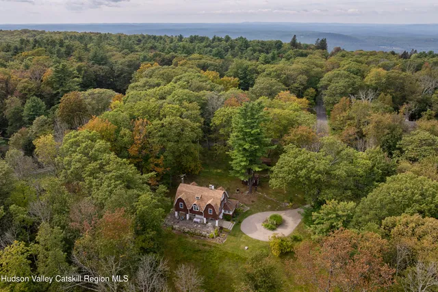 an aerial view of a house with a yard