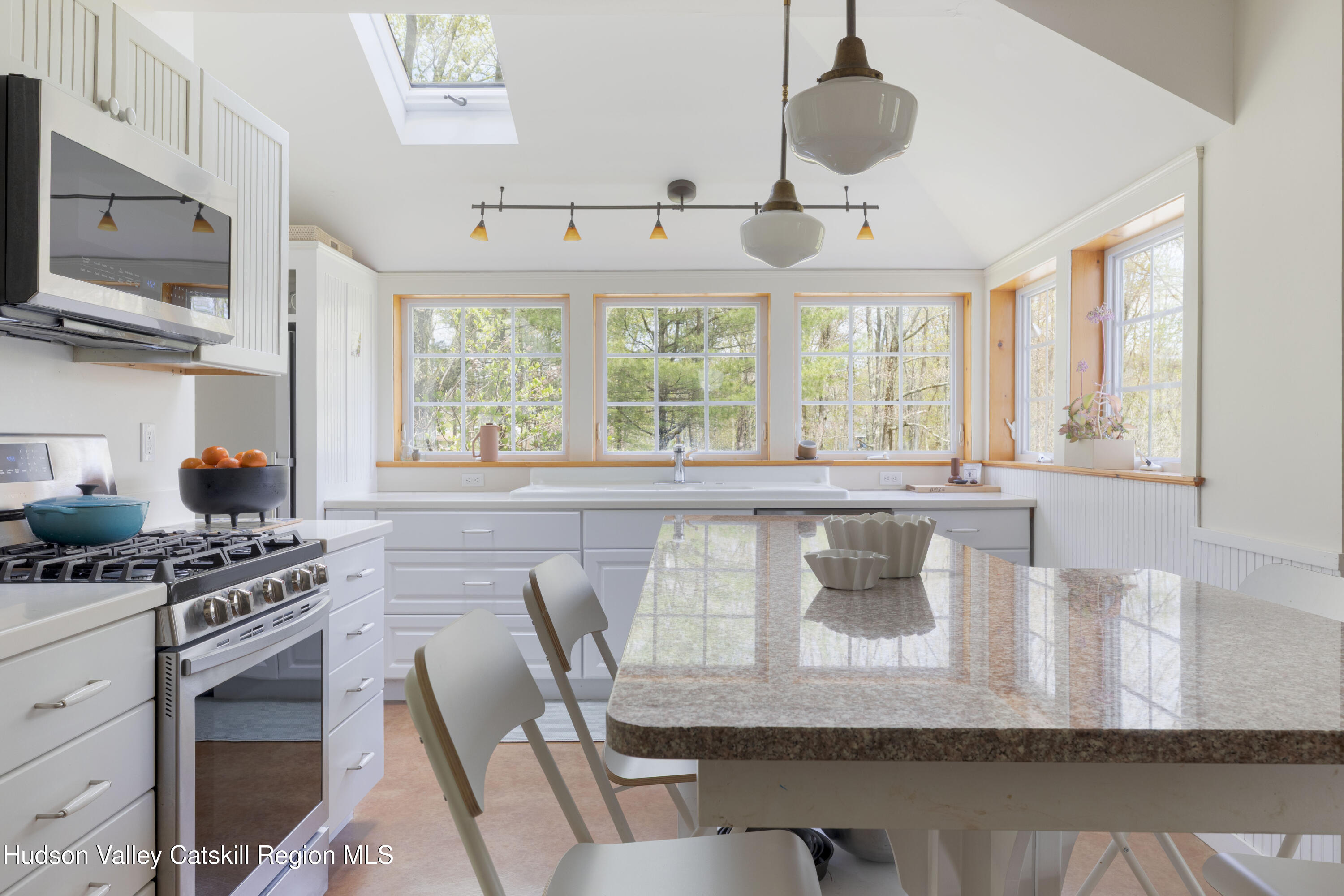 57 Dellenbaugh Road Cragsmoor, NY 12566 - Photo 7 of 26 a kitchen with a stove a sink and a dining table