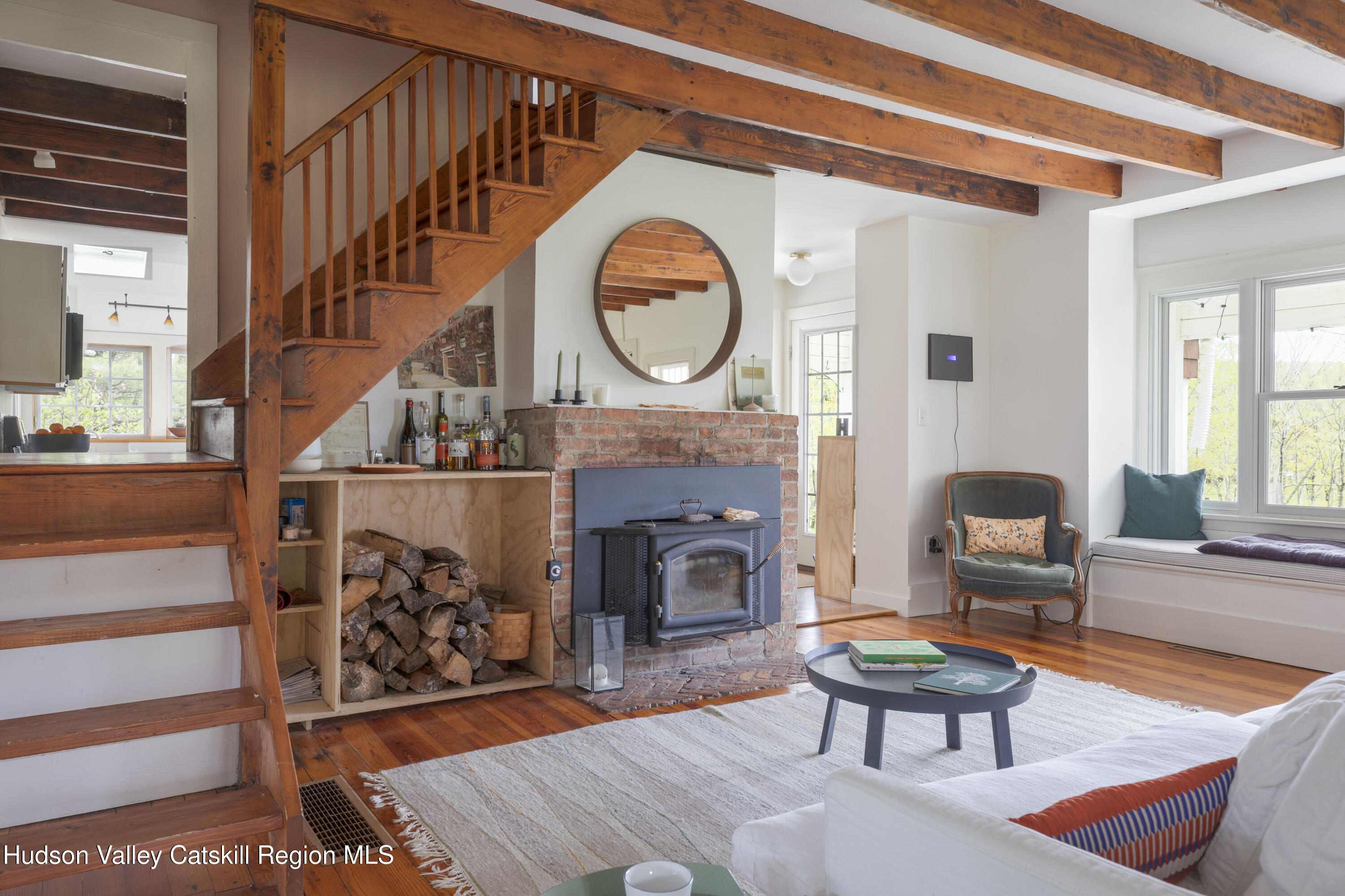 57 Dellenbaugh Road Cragsmoor, NY 12566 - Photo 9 of 26 a living room with furniture a fireplace and a large window