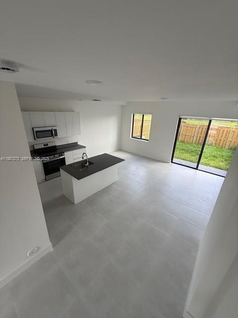 18944 Southwest 344th Terrace Homestead, FL 33034 - Photo 16 of 17 a kitchen with granite countertop a stove and a refrigerator