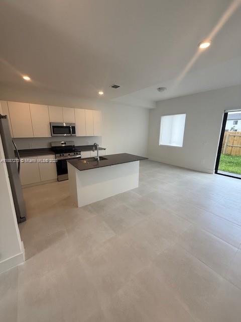 18944 Southwest 344th Terrace Homestead, FL 33034 - Photo 5 of 17 a kitchen with stainless steel appliances granite countertop a stove a sink and a refrigerator