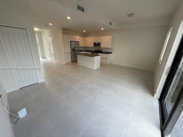 18944 Southwest 344th Terrace Homestead, FL 33034 - Photo 6 of 17 a view of kitchen with refrigerator stove and wooden floor