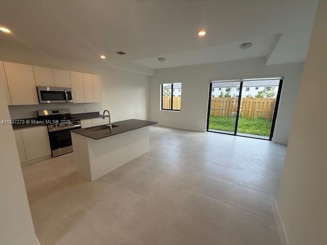 18944 Southwest 344th Terrace Homestead, FL 33034 - Photo 8 of 17 a kitchen with stainless steel appliances granite countertop a stove a sink and a refrigerator