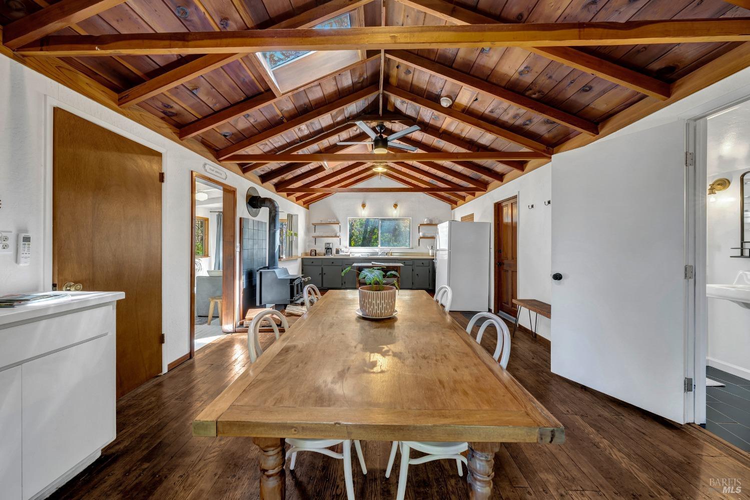a view of a dining room with furniture wooden floor and a chandelier